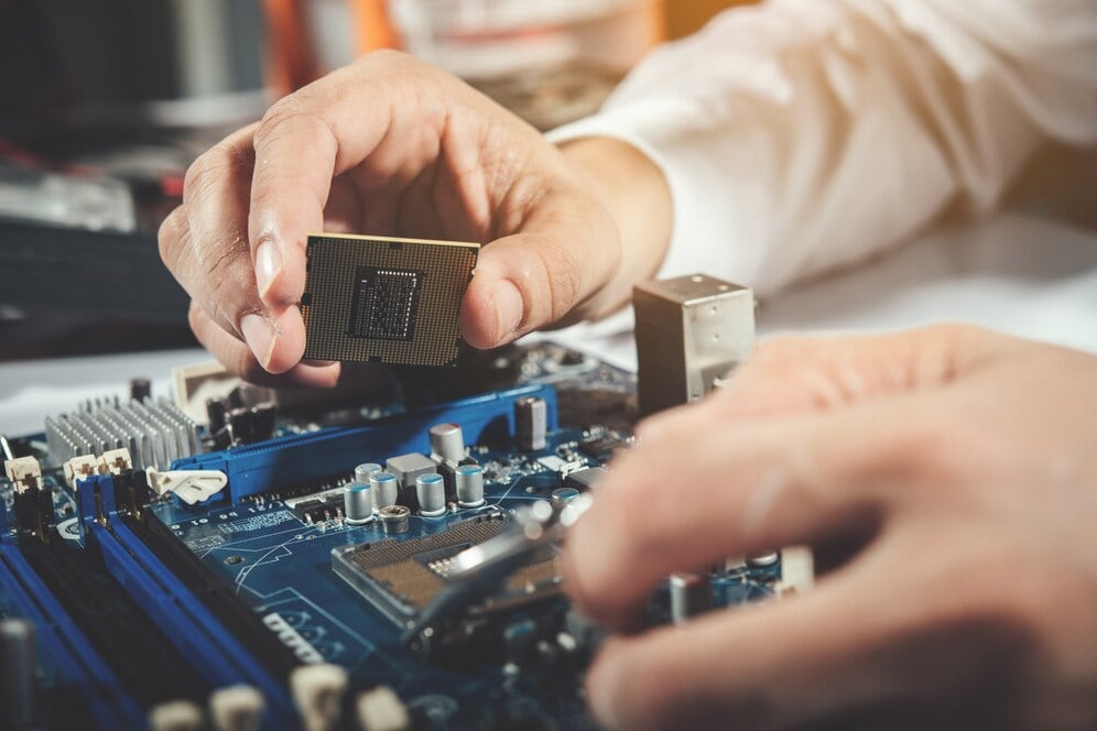 A technician working on computer hardware