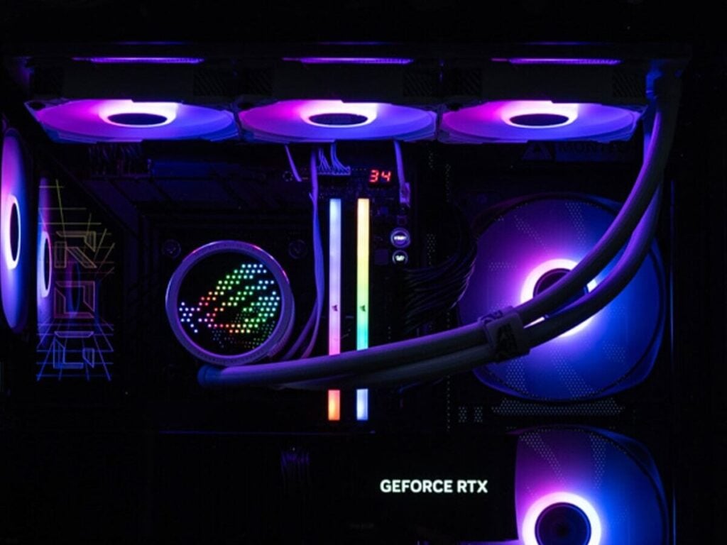 Close view of radiator fans, liquid-cooling tubes and RGB memory inside a gaming PC